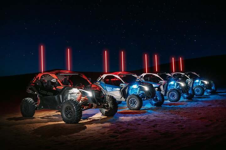 Experience the magic of moonlit dunes where powerful buggies illuminate the endless desert landscape offering a unique adventure under starry skies. The ultimate high awaits in Dubai's night hours.